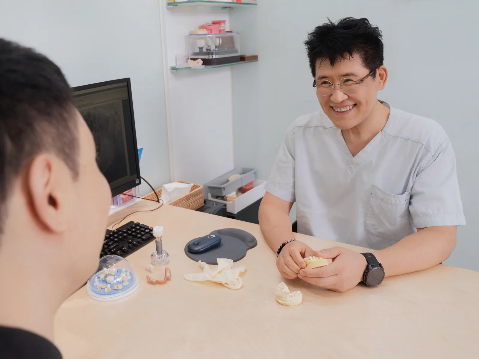 Dr. Chulmin Bae explaining a treatment plan during a consultation at Oaks Dental Clinic